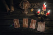 Tarot cards on fortune teller desk table background. Futune reading concept. Magic mirror on paranormal table.