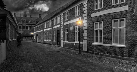 Sticker - Full moon over the street of the old town  - night landscape, Ribe, Denmark - Black And White