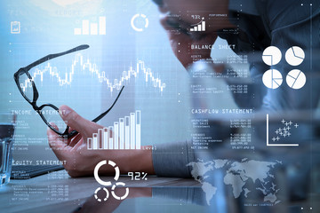 Poster - Businessman hand using mobile payments online shopping,pencil,omni channel,laptop computer on wooden desk in modern office