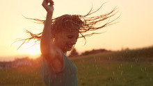 CLOSE UP Joyful Blonde Girl Enjoys Her Evening In Countryside By Dancing In Rain