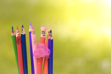 Happy colourful pencils on nature background 