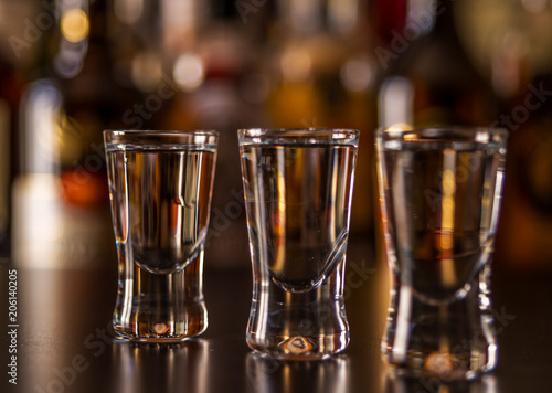 Fotografia Traditional pure vodka in glasses on a black background, chilled drink