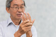 Asian elder suffer hand palm tendon muscle pain.