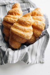 Delicious sweet croissants on table cloth, delicious homemade dessert