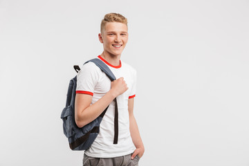 Sticker - Image of student boy having clean healthy skin wearing casual clothing and backpack smiling at camera, isolated over white background