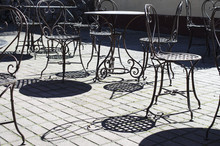 Summer Cafe With Wrought Iron Tables And Chairs