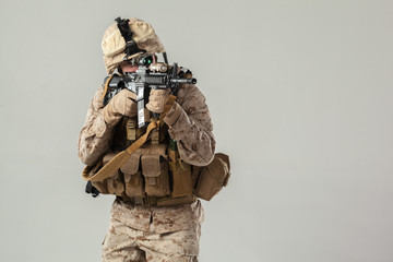 Wall Mural - Soldier in camouflage holding rifle