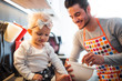 © leszekglasner - Young father cooking and takes care of little child in the kitchen at home