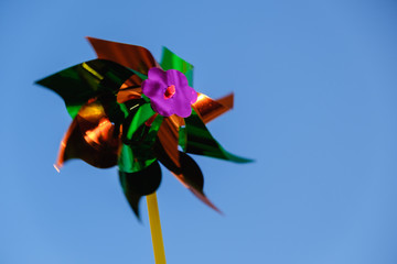 Colorful pinwheel against blue sky