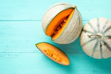 Cantaloupe melons on aquamarine background