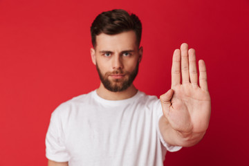 Sticker - Serious young man showing stop gesture