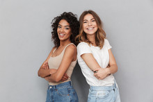 Portrait Of Two Cheerful Young Women Standing Together