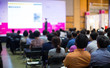© Right 3 - Audience at Conference Listening to Speaker Presenter Giving Talk at Meeting. Business Meeting in Conference Hall
