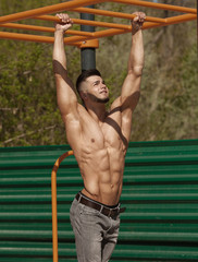 Wall Mural - Muscular man during his workout on the street