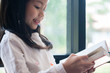© I Believe I Can Fly - cute girl smiled and standing reading book in the library, children concept, education concept