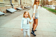 © bedya - Mother and her little daughter walking on the street