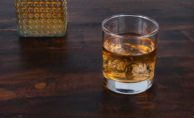 whisky on the rock on wood and wood background