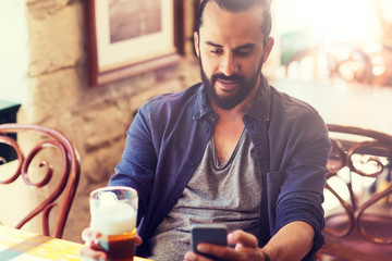 Sticker - people and technology concept - man with smartphone drinking beer and reading message at bar or pub