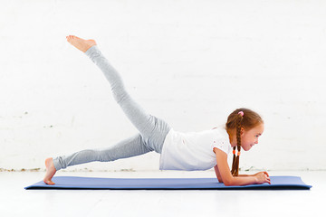 Wall Mural - child girl doing yoga and gymnastics in gym