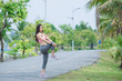 © reewungjunerr - Asian sporty woman stretching body breathing fresh air in the park,Thailand people,Fitness and  exercise concept