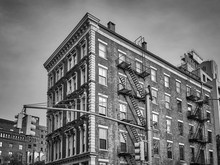 Black And White Picture Of An Old Building With Fire Escapes, New York City, USA.