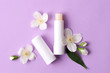 © White bear studio  - lip balm and flowers on a colored background. minimalism, the top