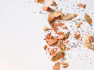 Colorful pencil shavings and pieces on white isolated background.