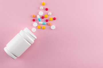 colorful pills spilling out of the medicine bottle with copy space