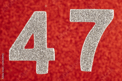 Poster Number forty-seven silver color over a red background