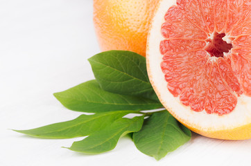 Wall Mural - Colorfull juicy slice grapefruit on white wood board, macro, copy space.