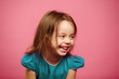 © Ilshat - Portrait of beautiful little girl laughing happily on pink isolated background.