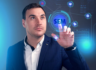 Business, Technology, Internet and network concept. Young businessman working on a virtual screen of the future and sees the inscription: SEM