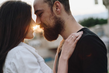 Couple has fun and laughs. Young hipster couple hugging each other in city. Summer love story, beautiful stylish young couple. Spring fashion urban concept with boyfriend and girlfriend. Select focus