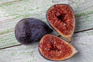 Wall Mural - Group of fig halves on a white rustic table