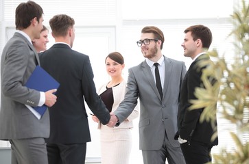 handshake business partners in the office