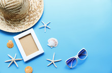 Beach Hat And Picture Frame With Starfish,Shell On Blue Table In The Summer Asia,copy Space,Top View,minimal Style