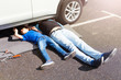 © Sergey Novikov - Father teaching son to repair car lying under auto