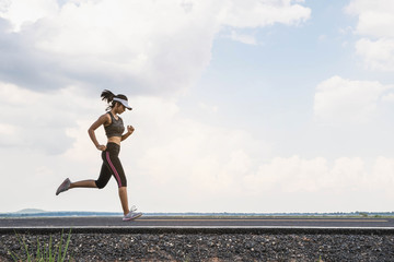 young fitness woman runner athlete running at road. young woman runner on the street be running for 
