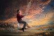 Man in red sweater sitting on the pendulum of a grandfather clock which is swinging in the air on twilight background
