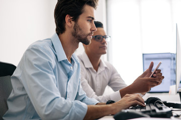 Application developers working on computers in office