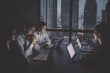 © S photographer - Business Overtime Concepts . Group of business people working overtime in nighttime. Businessmen are serious about office work. Businessmen working late at night after work.