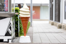 Vintage Plastic Promotional Ice Cream Cone With Vanilla Whipped Ice Cream And A Chocolate Flake Outside A Mall Or Shopping Centre In The UK