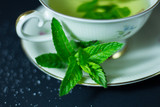 Fototapeta  - Ziołowa herbatka ze świeżej mięty w filiżance
