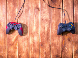 Poster - two video game devices on the wooden table with copy space