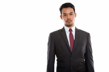 Studio shot of young Asian businessman