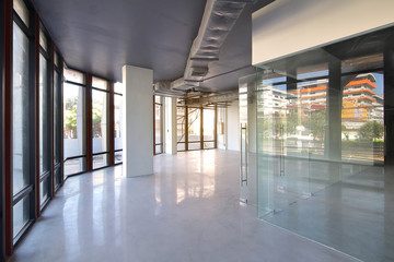 Bangkok,Thailand - October 19 , 2017 : Empty office room on modern building with sunlight and indoor ventilation system on hight ceiling of large building.