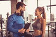 © Mladen - Couple talking at gym.