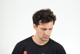 Fototapeta  - Sad man in T-shirt looking down