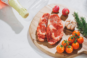 Raw fresh beef on white stone background, top view