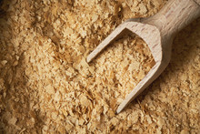 Nutritional Brewers Yeast Flakes With Wooden Scoop. Top View With Copy Space